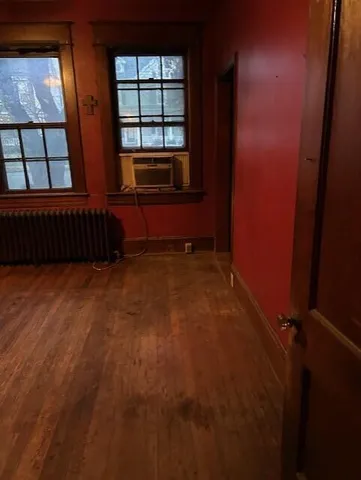 wooden floor in an empty room with windows