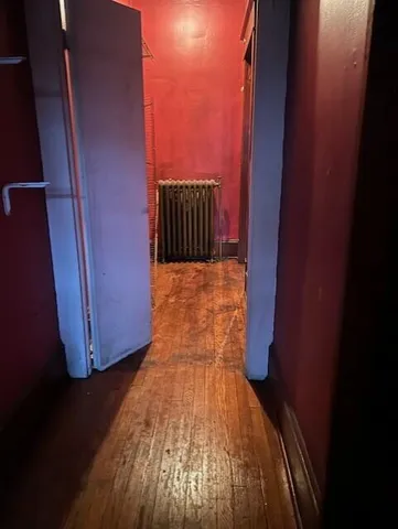 a view of hallway with wooden floor