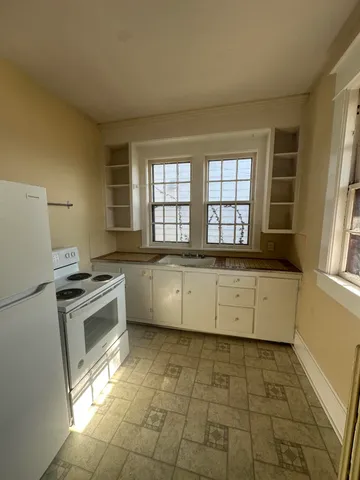 a kitchen with a stove a sink and a refrigerator
