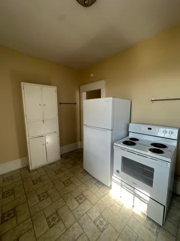 a kitchen with a stove and a refrigerator