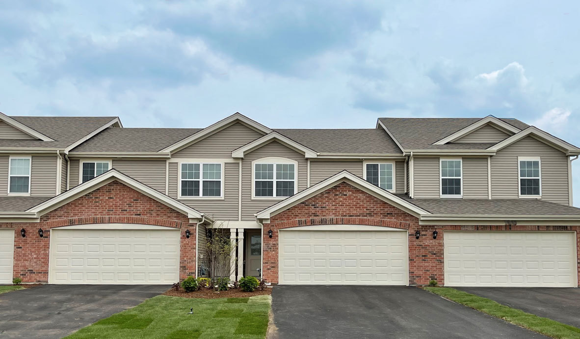 18 West Lake Court Cary, IL 60013 - Photo 1 of 21 a front view of a house with a yard and garage