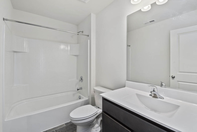 18 West Lake Court Cary, IL 60013 - Photo 16 of 21 a bathroom with a sink toilet vanity and shower