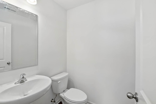 18 West Lake Court Cary, IL 60013 - Photo 3 of 21 a white toilet sitting next to a white sink