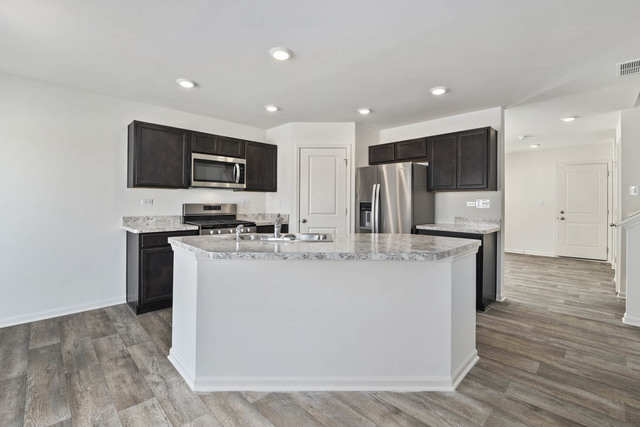 18 West Lake Court Cary, IL 60013 - Photo 8 of 21 a kitchen with stainless steel appliances a refrigerator and a stove top oven