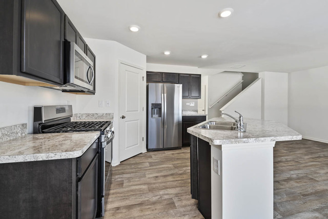 18 West Lake Court Cary, IL 60013 - Photo 9 of 21 a kitchen with stainless steel appliances granite countertop a sink stove and refrigerator