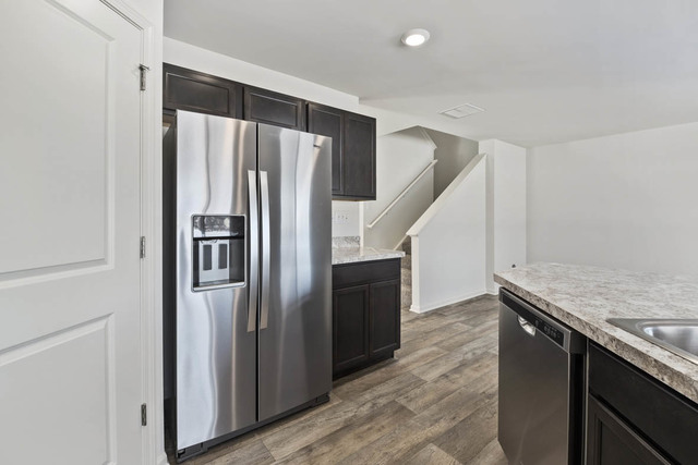 18 West Lake Court Cary, IL 60013 - Photo 10 of 21 a kitchen with granite countertop a refrigerator and a sink