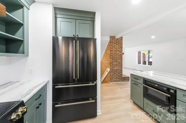 a kitchen with granite countertop stainless steel appliances and wooden cabinets