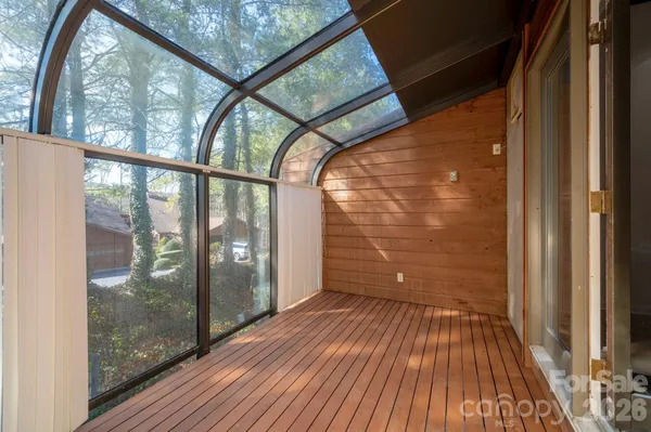 a view of entrance with wooden floor and door
