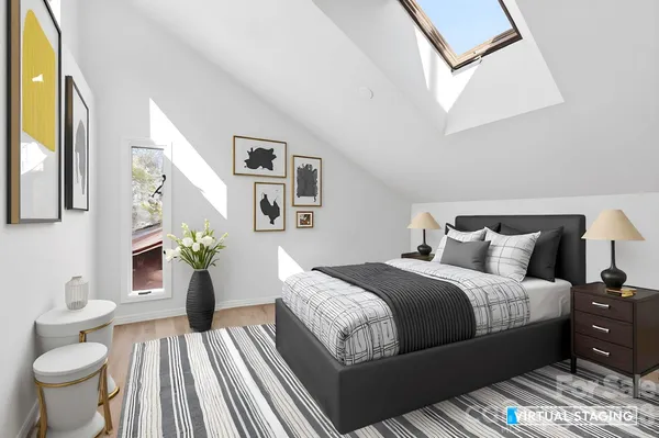 a spacious bedroom with a bed and wooden floor