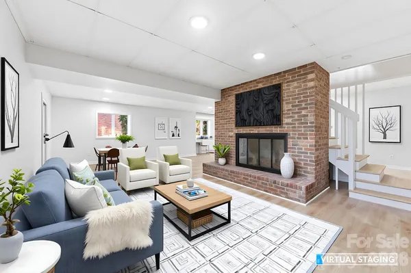 a living room with furniture a rug and a fireplace