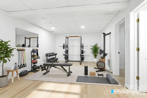 a living room with furniture a potted plant and a large window