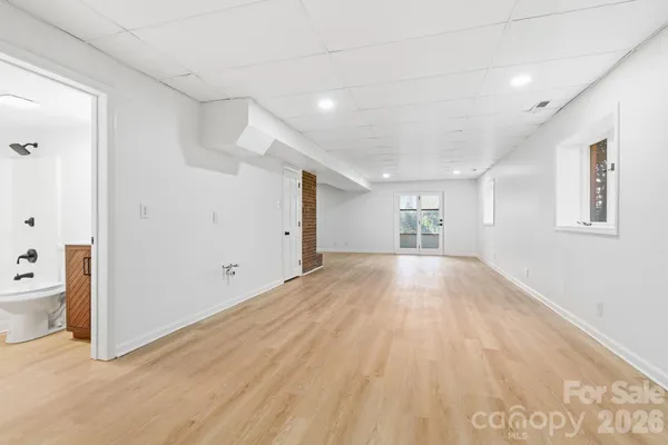 a view of empty room with wooden floor