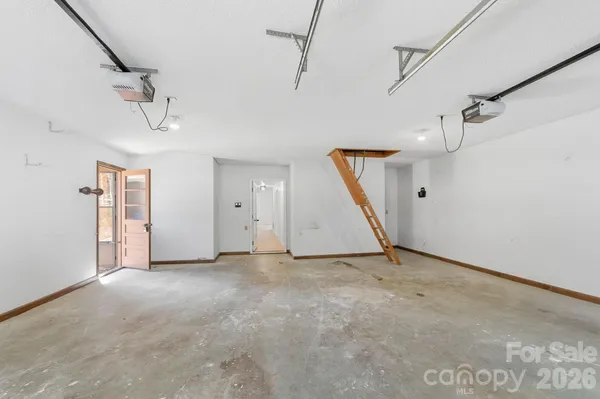 an empty room with windows and cabinet
