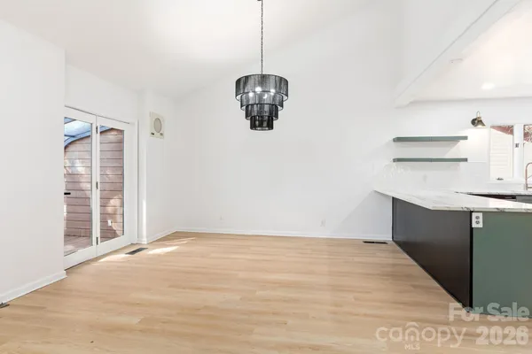 a view of a room with wooden floor and windows