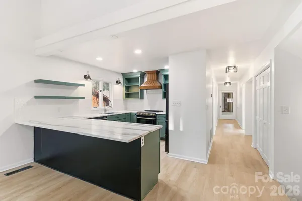a kitchen with stainless steel appliances granite countertop a refrigerator and a sink