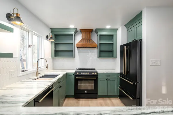 a kitchen with granite countertop stainless steel appliances and wooden cabinets