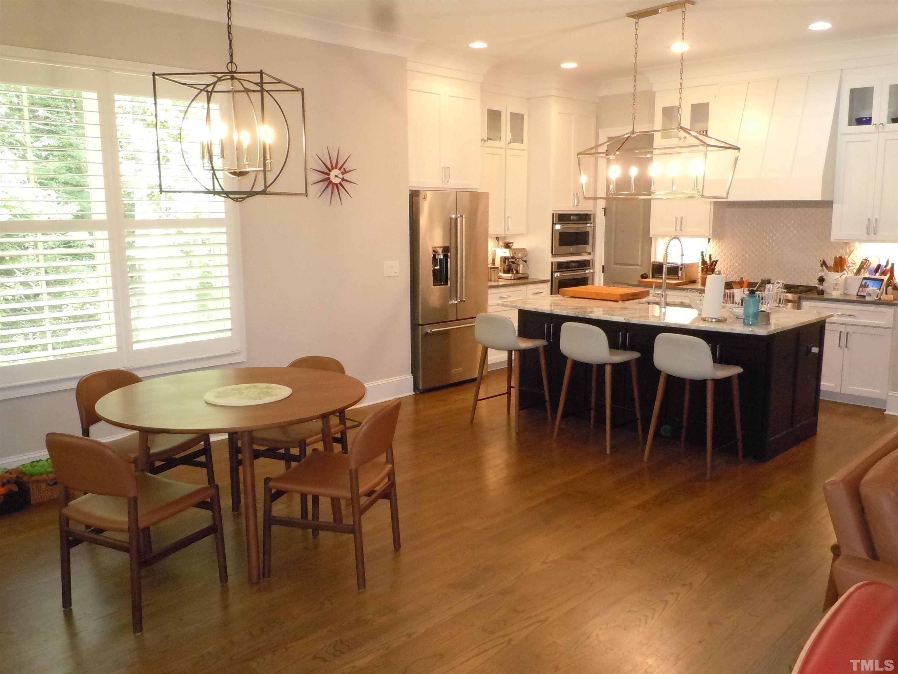 1009 Marilyn Drive Raleigh, NC 27607 - Photo 10 of 36 a dining room with stainless steel appliances kitchen island a table chairs and a kitchen view