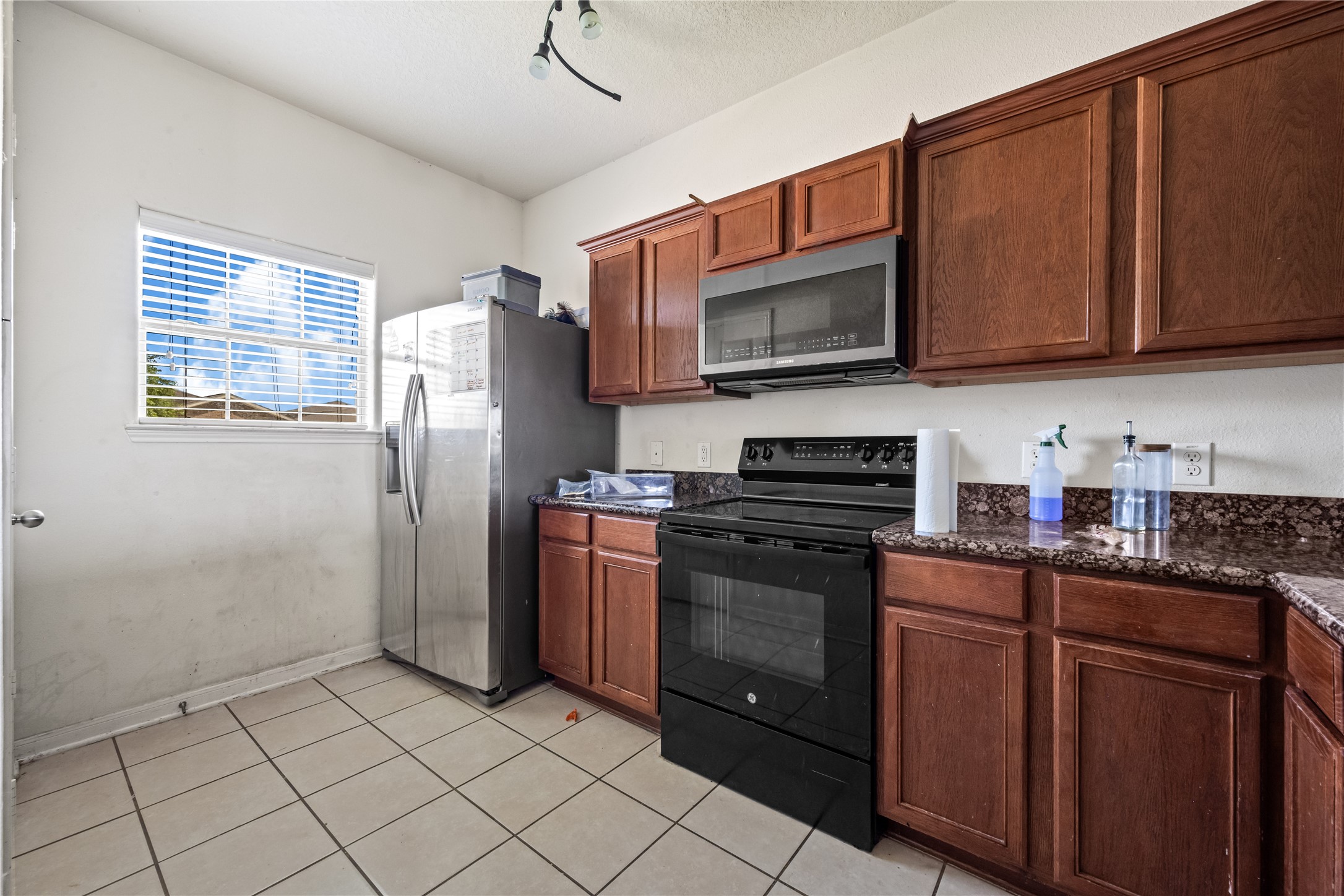 28832 San Bernard River Loop Spring, TX 77386 - Photo 14 of 50 a kitchen with stainless steel appliances granite countertop a refrigerator stove top oven and sink