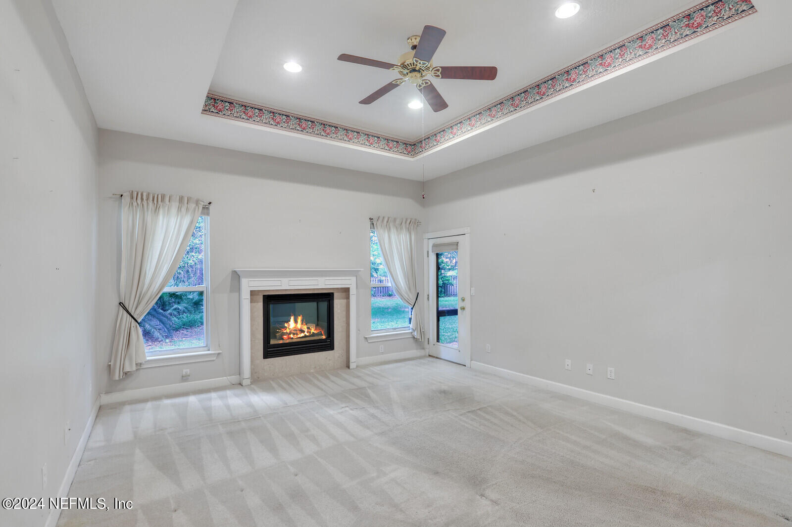 895 Roberts Road St. Johns, FL 32259 - Photo 17 of 42 a view of a livingroom with a fireplace a ceiling fan and a rug