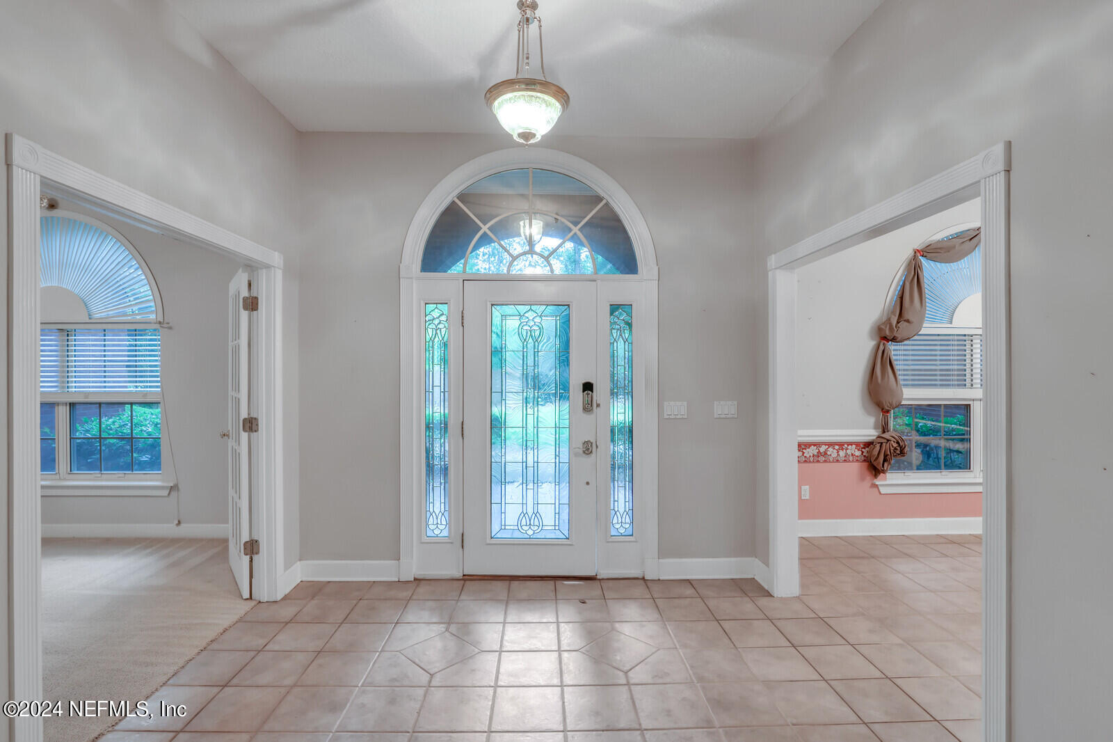 895 Roberts Road St. Johns, FL 32259 - Photo 4 of 42 an empty room that has a large window and cabinets