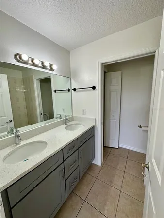 a bathroom with a double vanity sink mirror and double