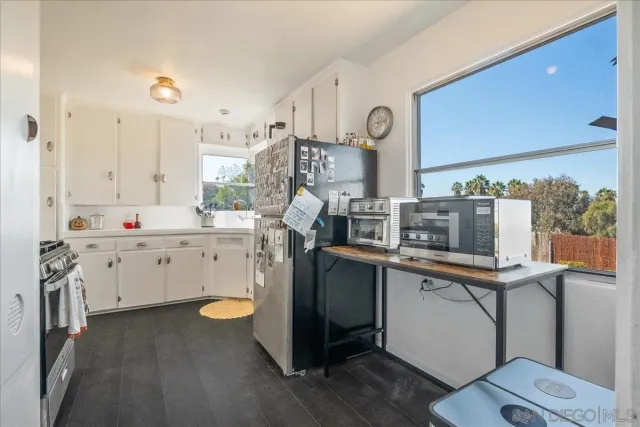 a kitchen with stainless steel appliances a refrigerator sink and cabinets