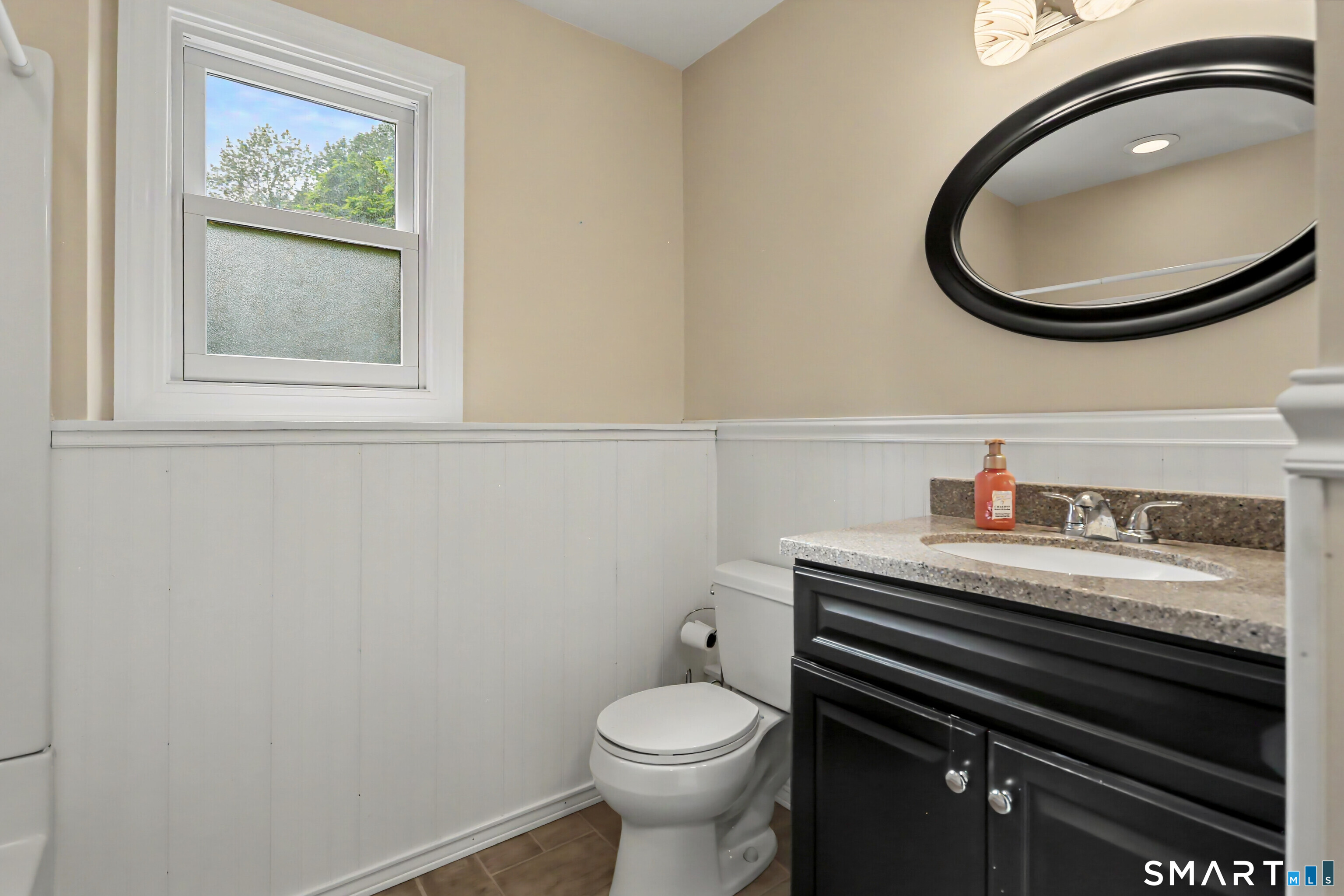 632 Wheelers Farm Road Orange, CT 06477 - Photo 28 of 39 a bathroom with a toilet a sink and mirror
