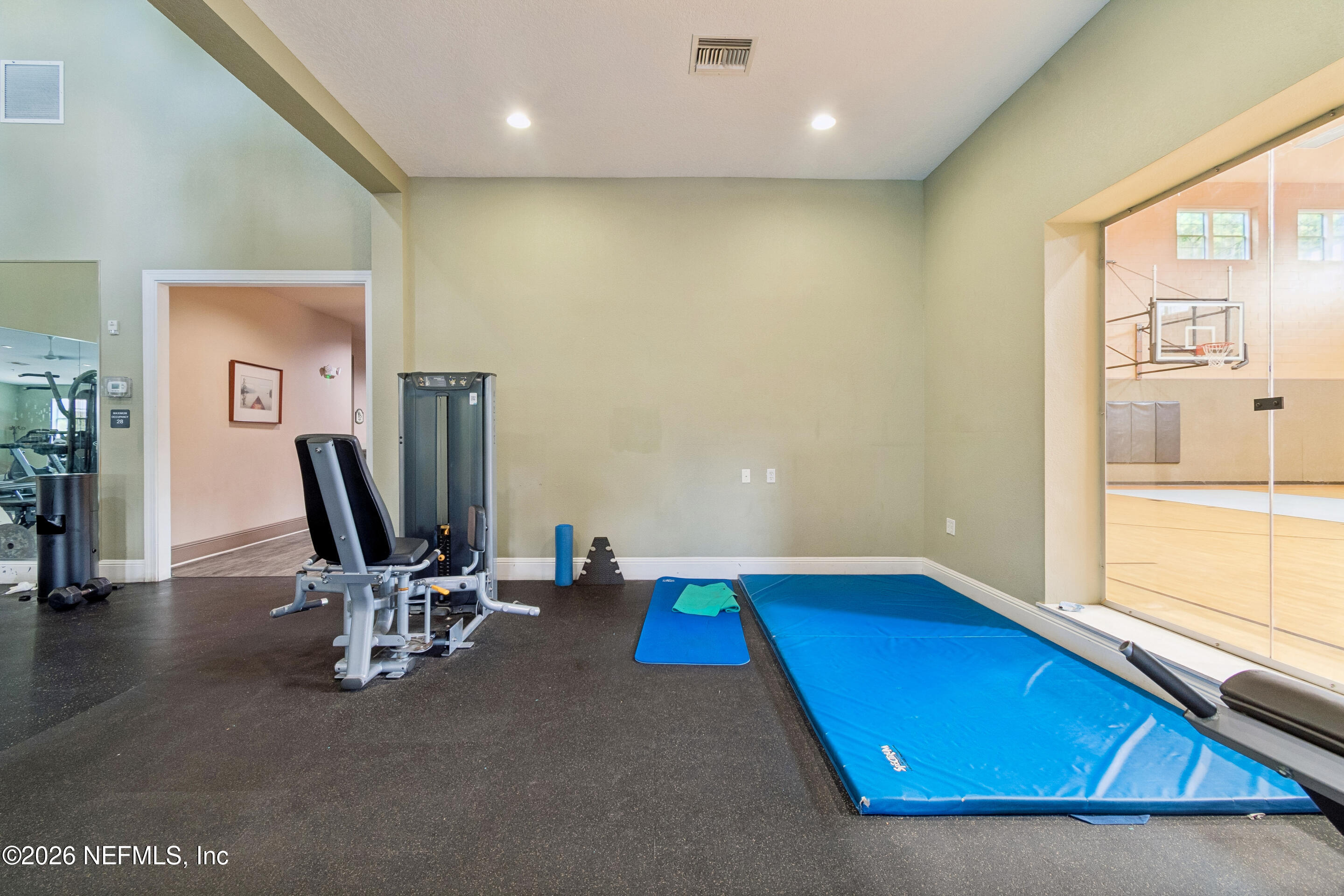 8550 Touchton Road, Unit 511 Jacksonville, FL 32216 - Photo 61 of 63 a room with gym equipment and a large window