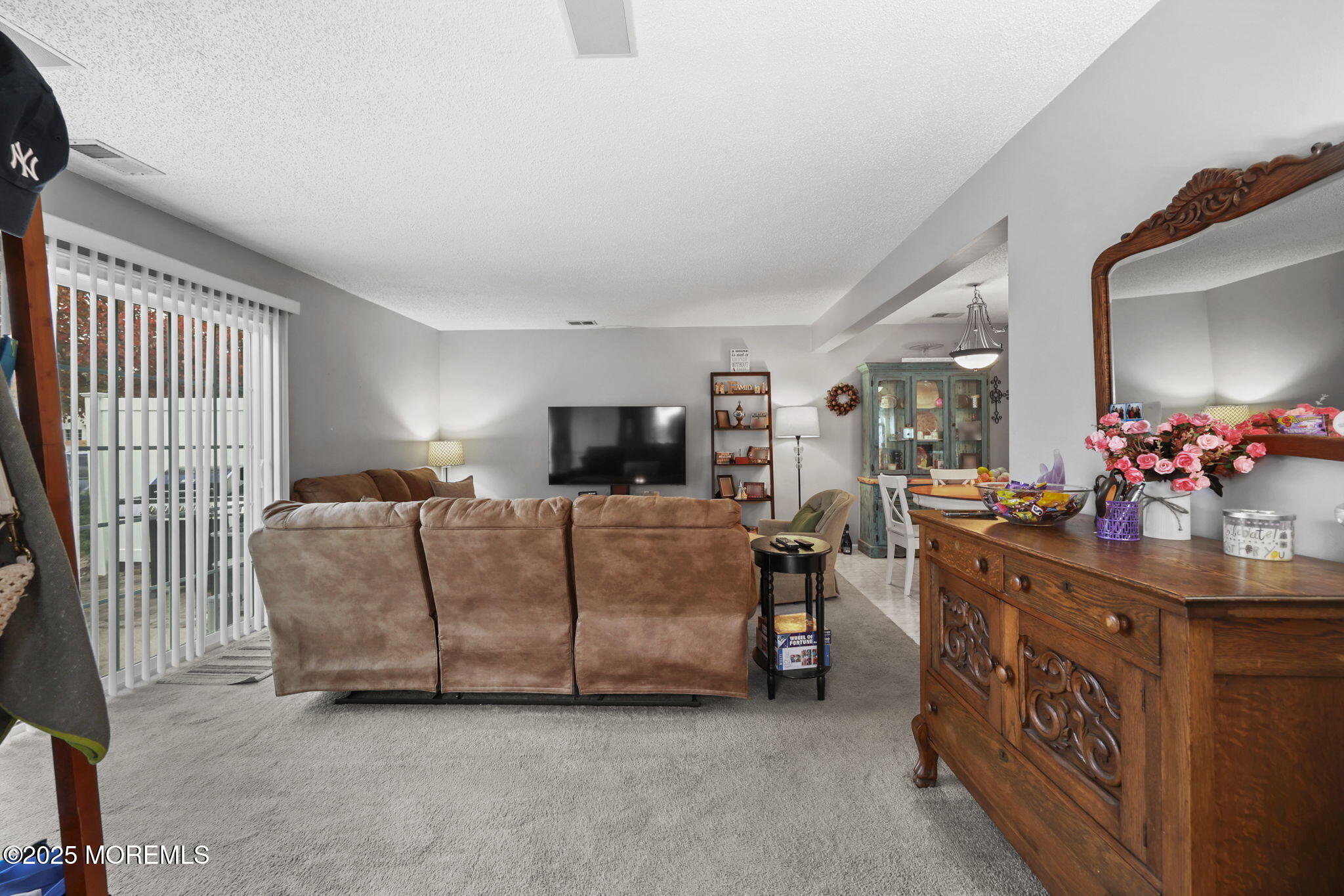 2 Madison Court Tinton Falls, NJ 07712 - Photo 7 of 22 a living room with furniture a flat screen tv and a table