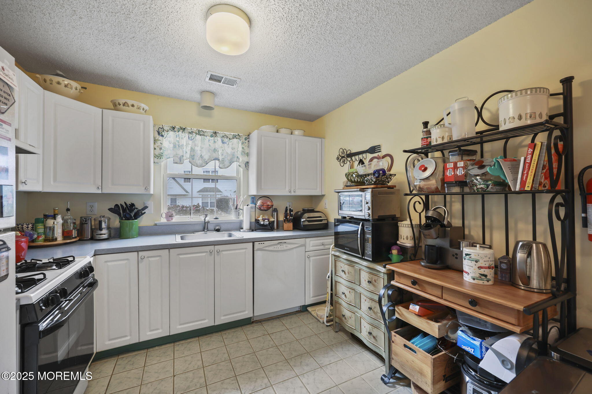 2 Madison Court Tinton Falls, NJ 07712 - Photo 10 of 22 a kitchen with stainless steel appliances granite countertop a sink and cabinets