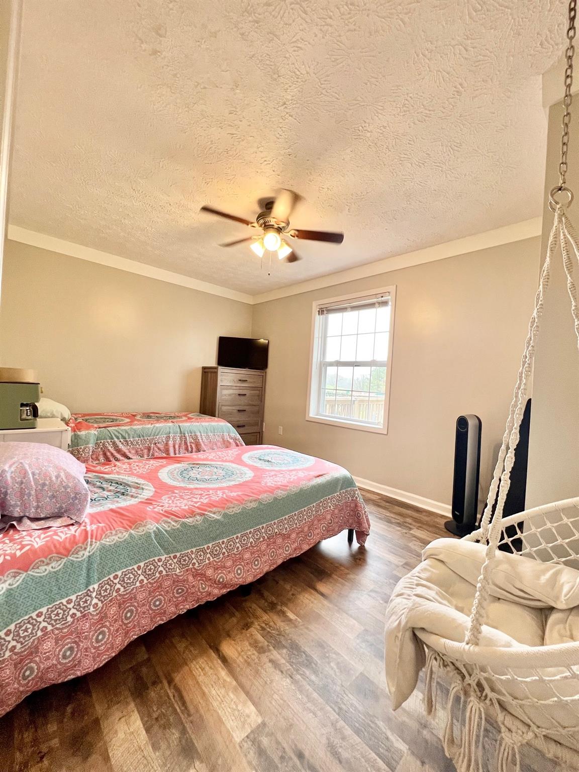 2245 Huckleberry Ridge Road Hiddenite, NC 28636 - Photo 2 of 13 a bedroom with a bed and a window with the dresser