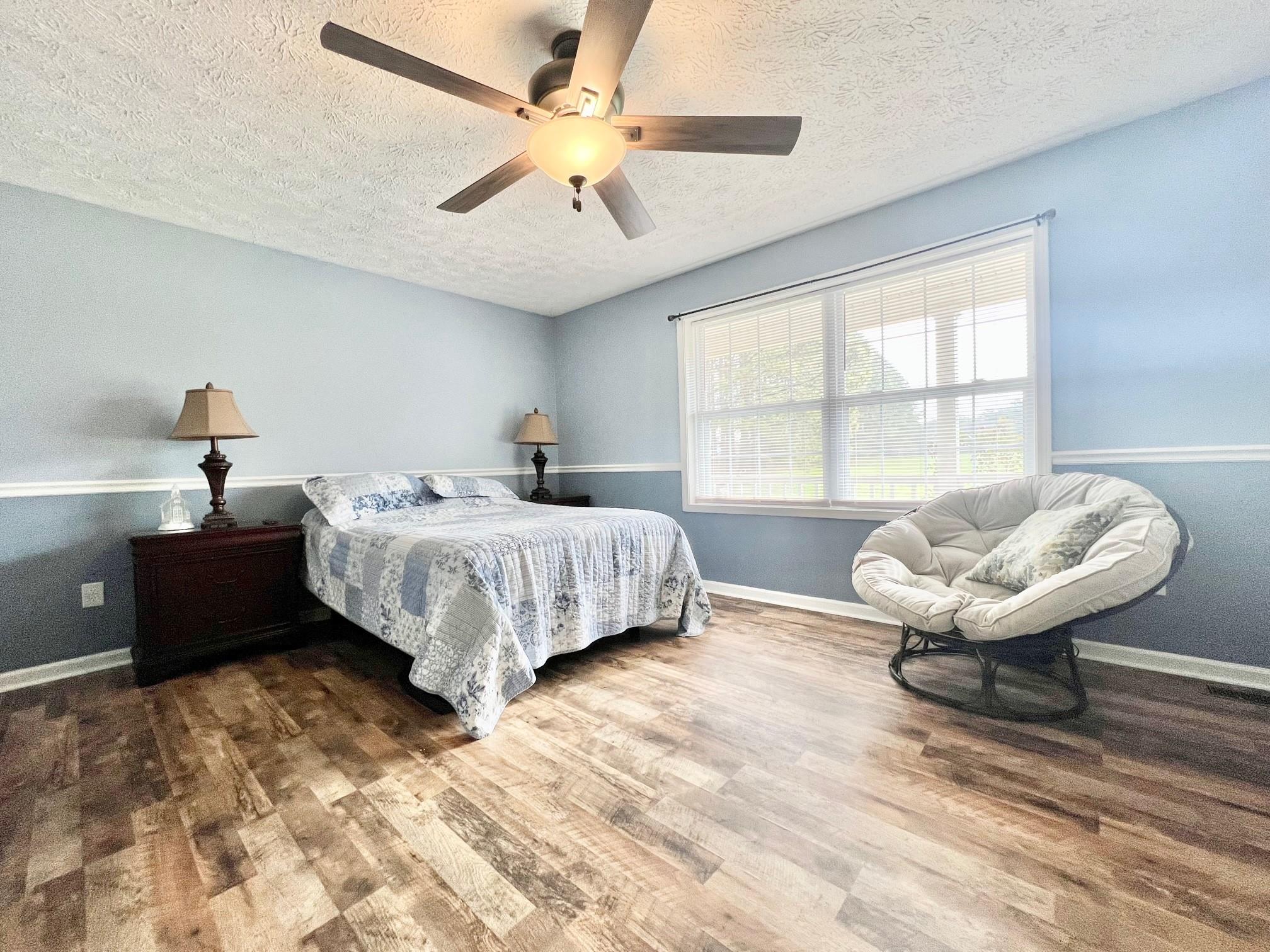 2245 Huckleberry Ridge Road Hiddenite, NC 28636 - Photo 3 of 13 a spacious bedroom with a bed and a window