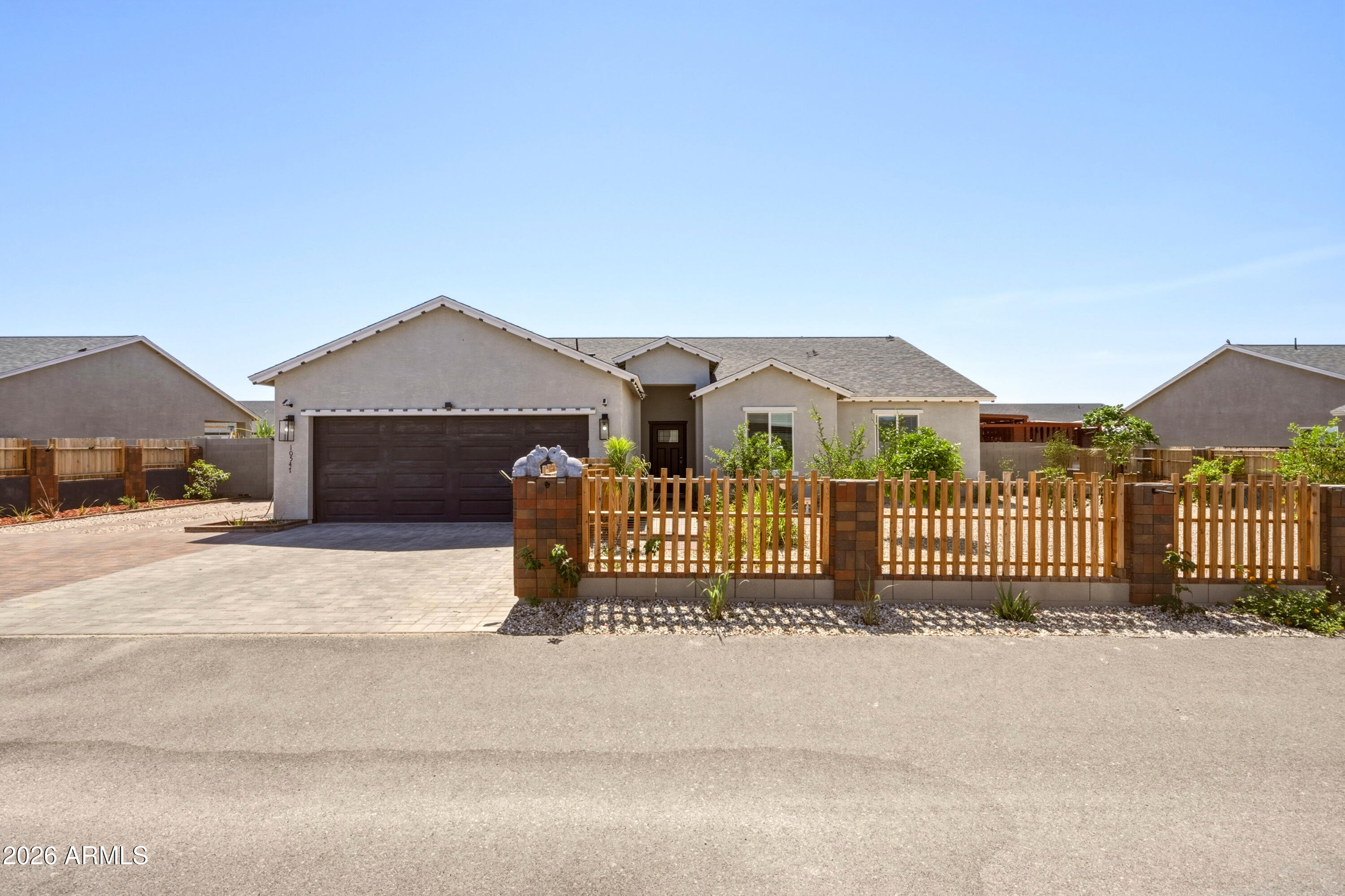 10547 East Baltimore Street Apache Junction, AZ 85120 - Photo 1 of 43 a front view of a house with a garden