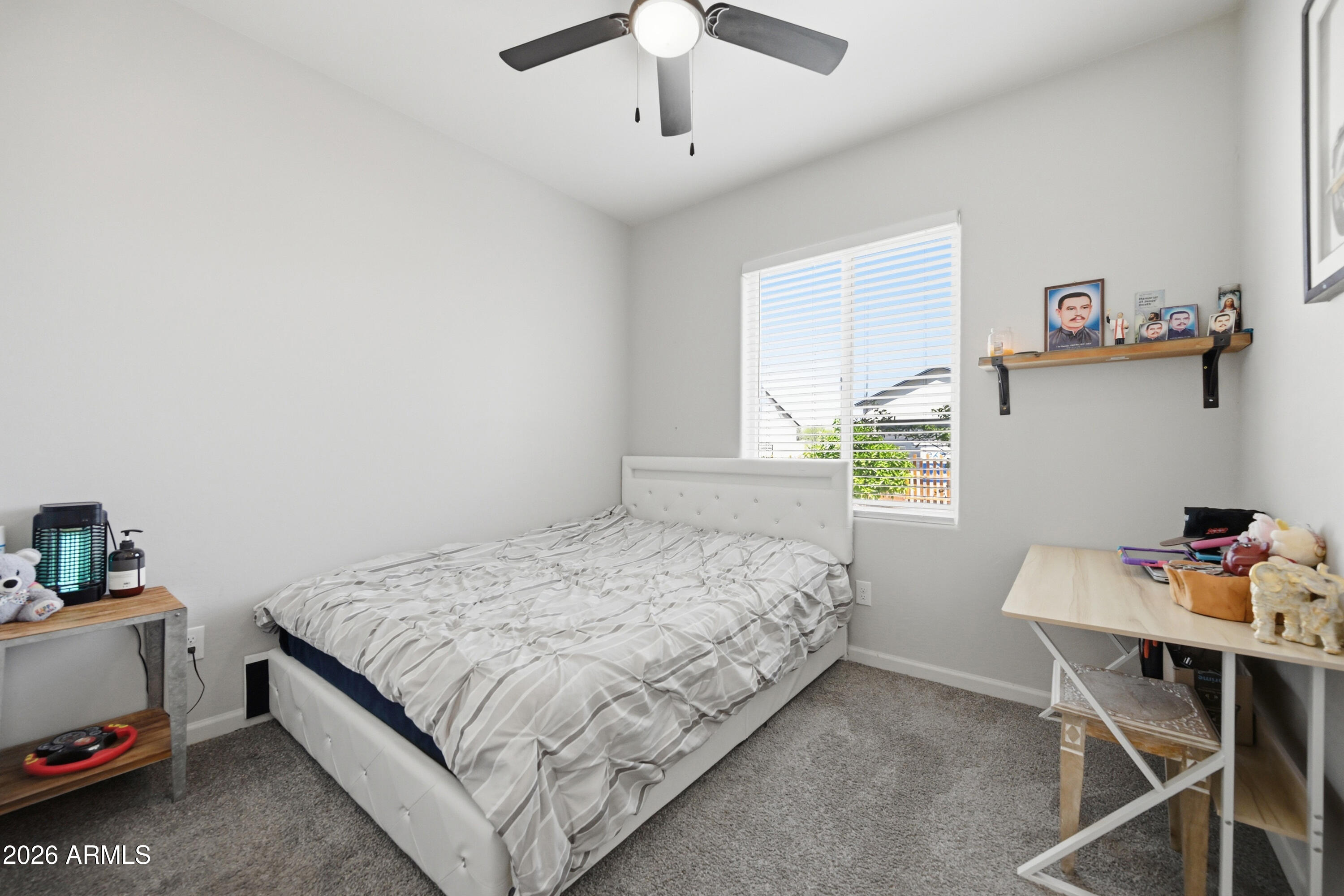 10547 East Baltimore Street Apache Junction, AZ 85120 - Photo 16 of 43 a bedroom with a bed and a table in it