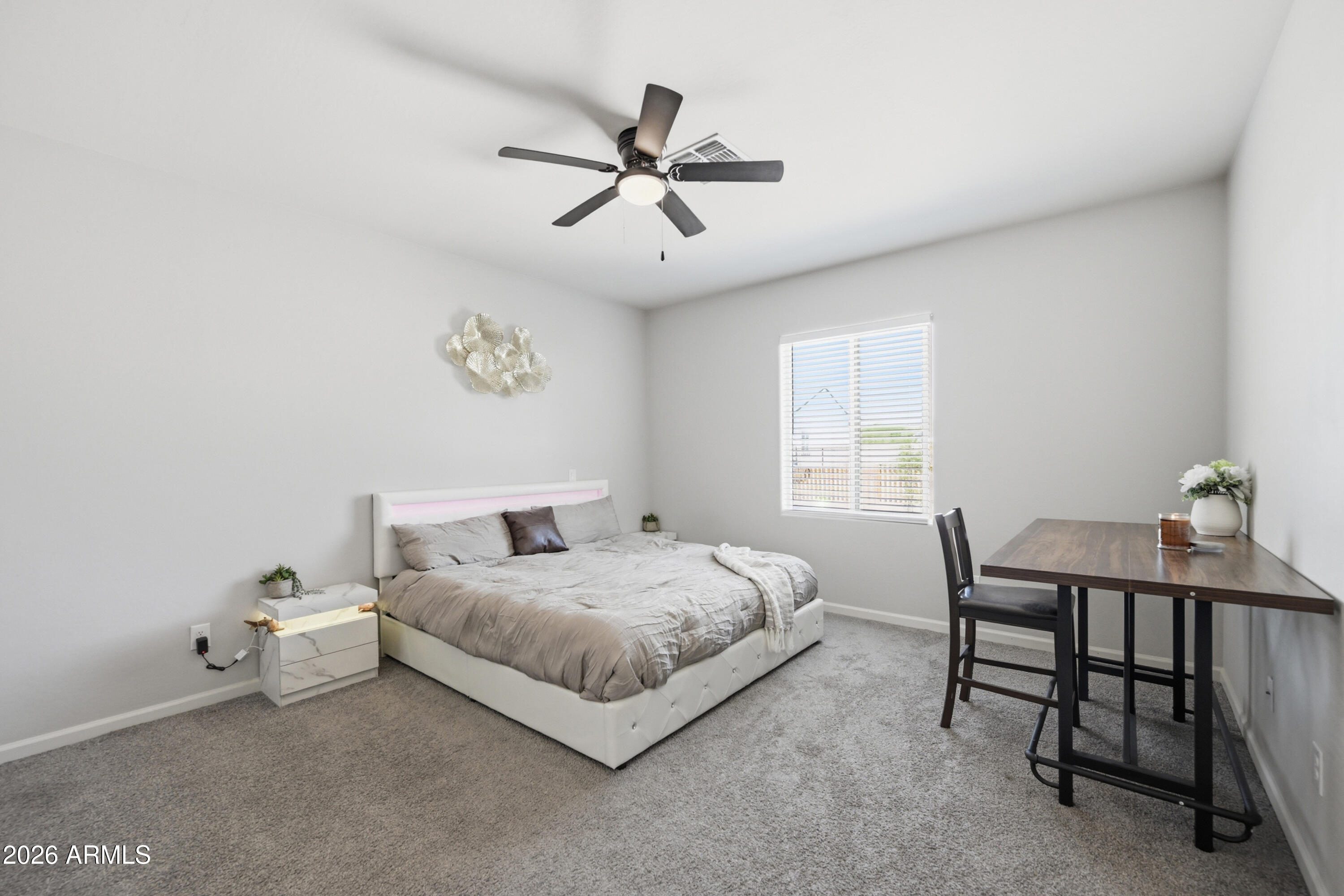 10547 East Baltimore Street Apache Junction, AZ 85120 - Photo 18 of 43 a bedroom with a bed and a table in it