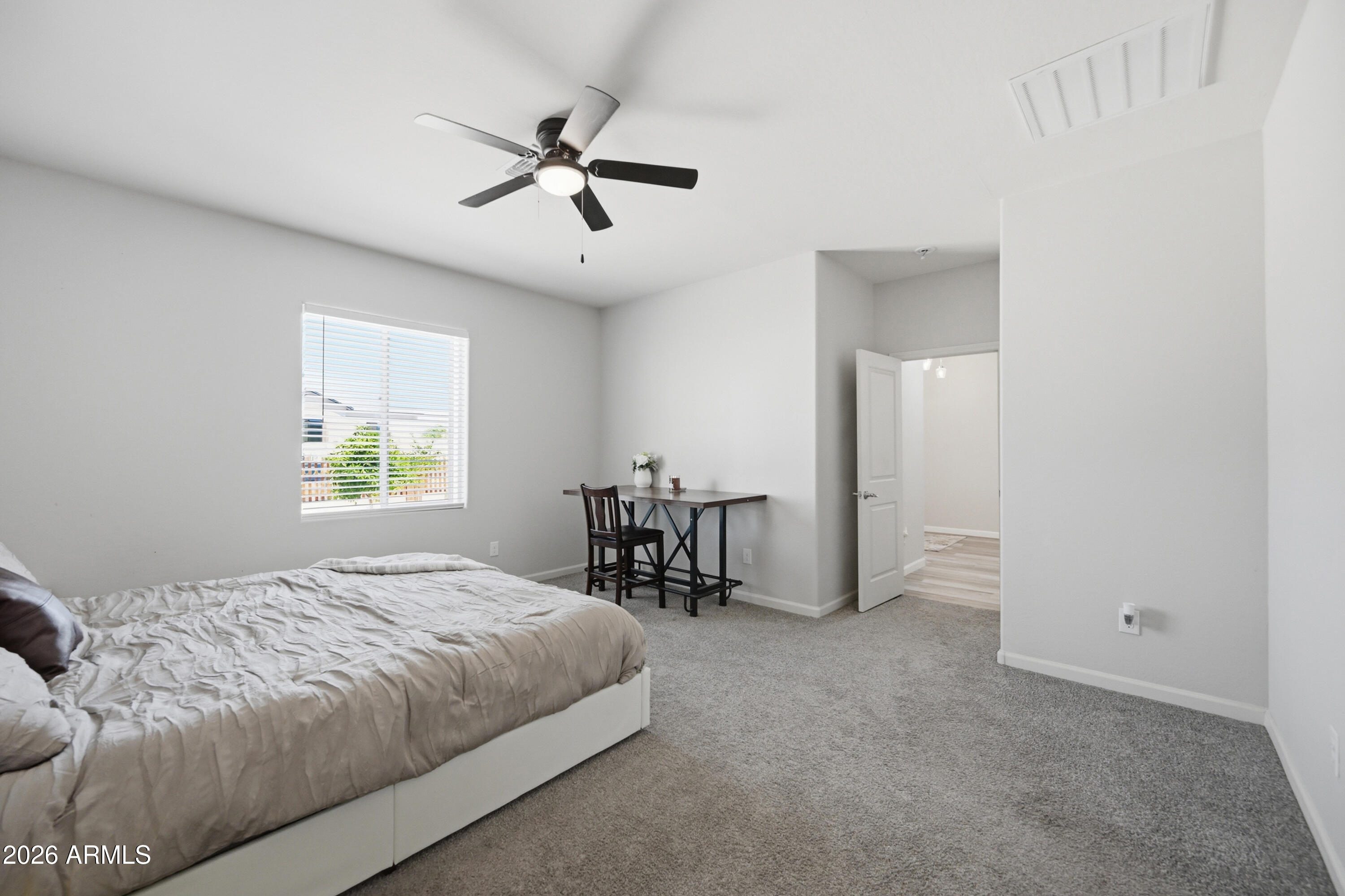 10547 East Baltimore Street Apache Junction, AZ 85120 - Photo 19 of 43 a bedroom with a bed and a table