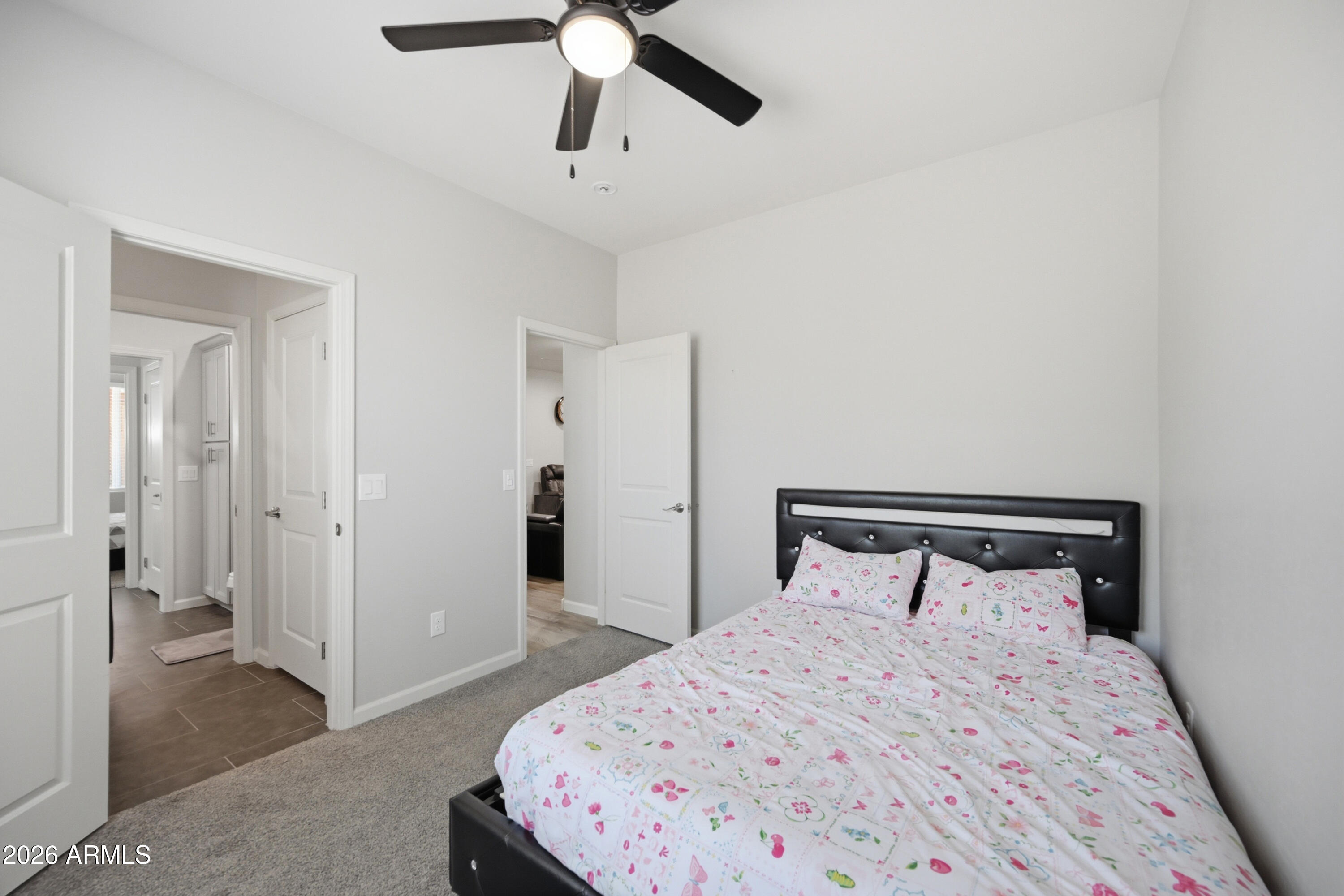 10547 East Baltimore Street Apache Junction, AZ 85120 - Photo 30 of 43 a bedroom with a bed and a chandelier