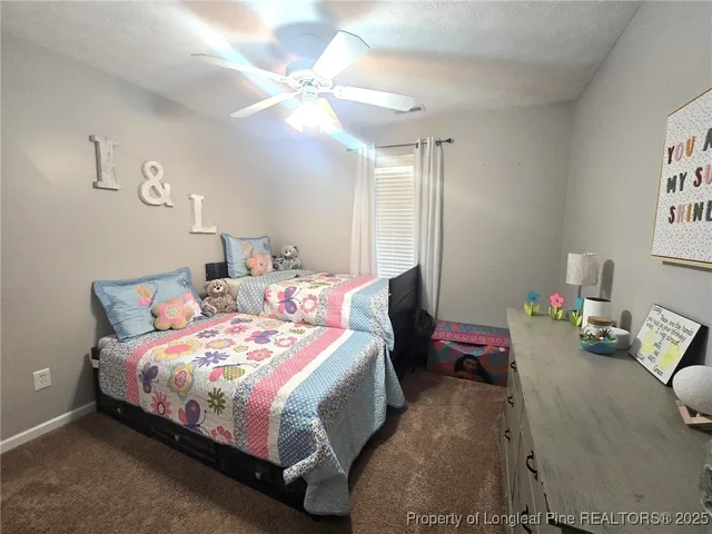 a bedroom with bed and a chandelier