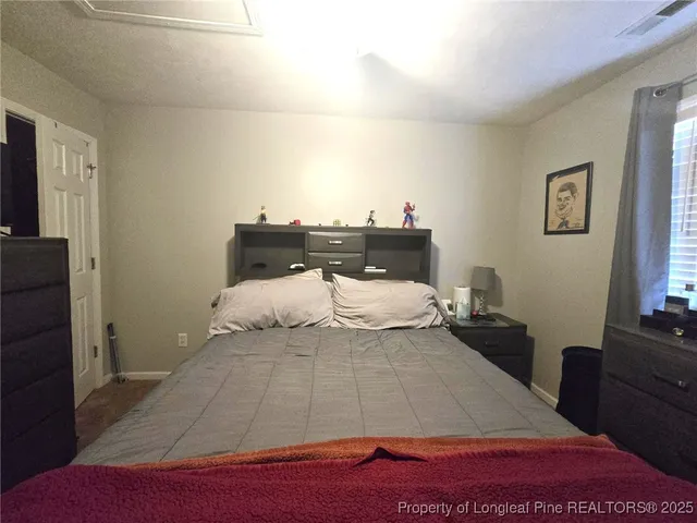 a room with a bed and a night stand