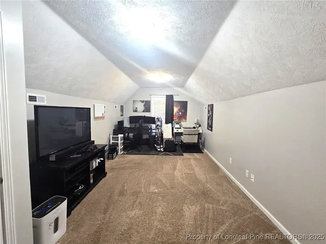 a view of a livingroom with furniture and a flat screen tv