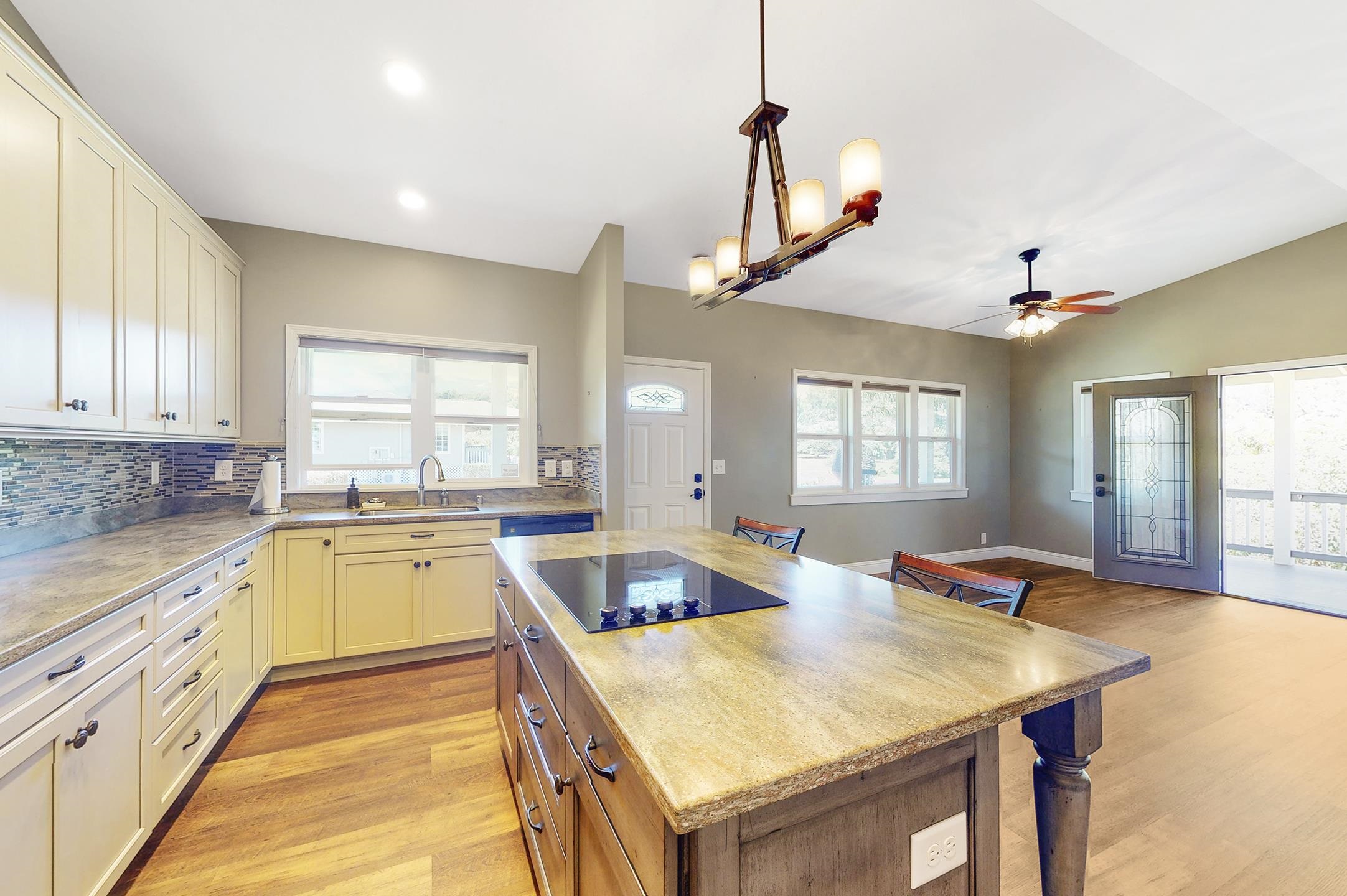 1480 Hog Back Road, Unit 1480 HOG BACK ROAD Haiku, HI 96708 - Photo 16 of 29 a large kitchen with kitchen island a stove a sink a center island and windows