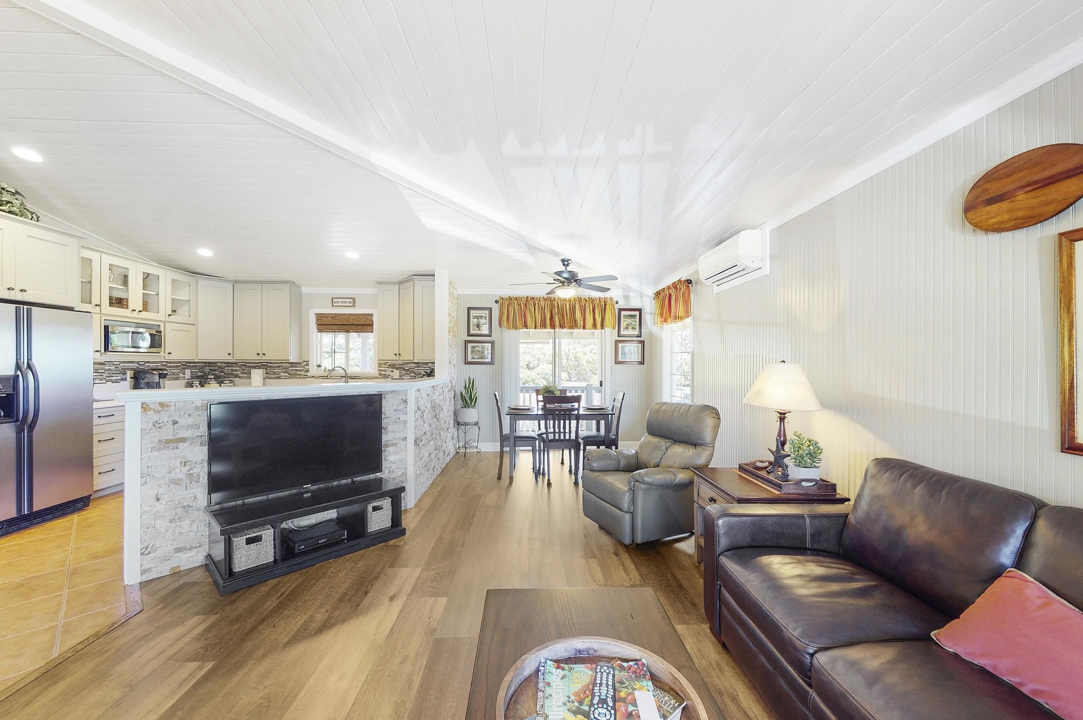 1480 Hog Back Road, Unit 1480 HOG BACK ROAD Haiku, HI 96708 - Photo 2 of 29 a living room with furniture and a flat screen tv