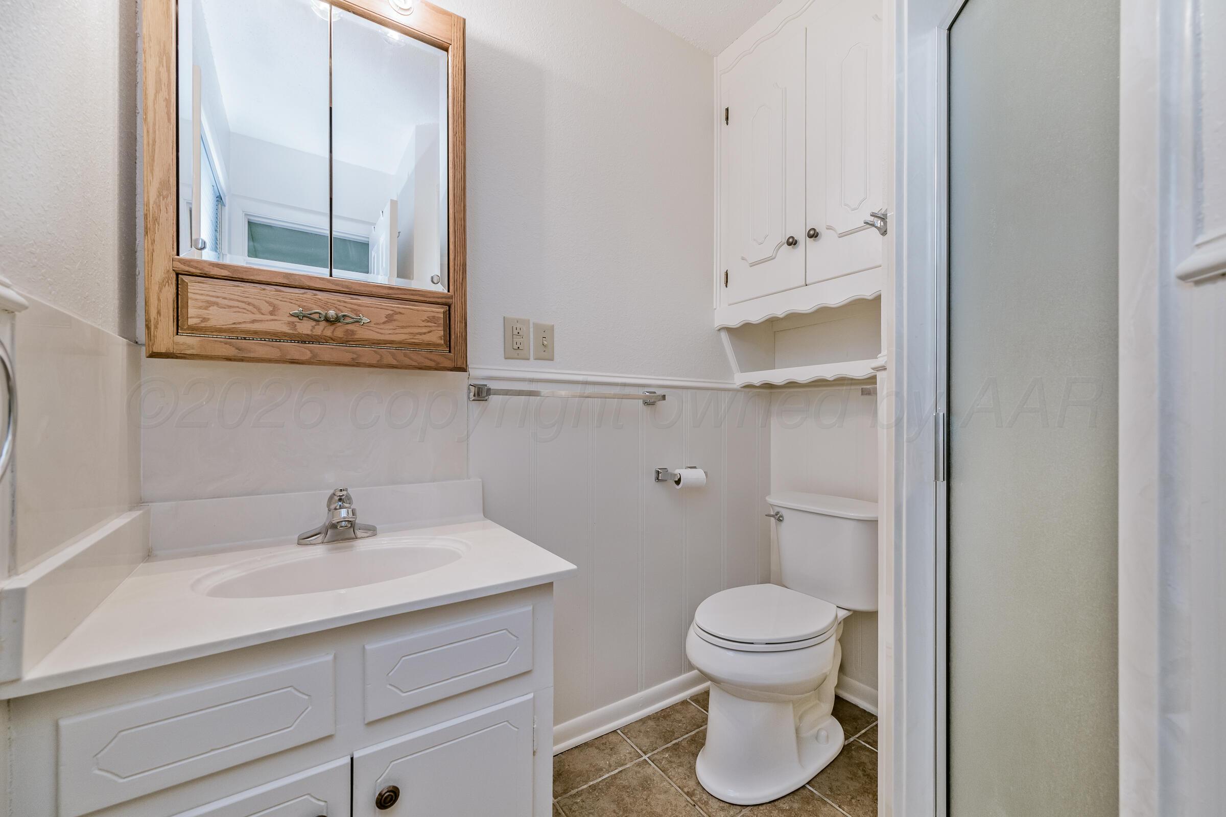 4400 West Farmers Avenue Amarillo, TX 79110 - Photo 27 of 27 a bathroom with a toilet sink and mirror