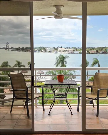 a view of a chairs and table in the balcony