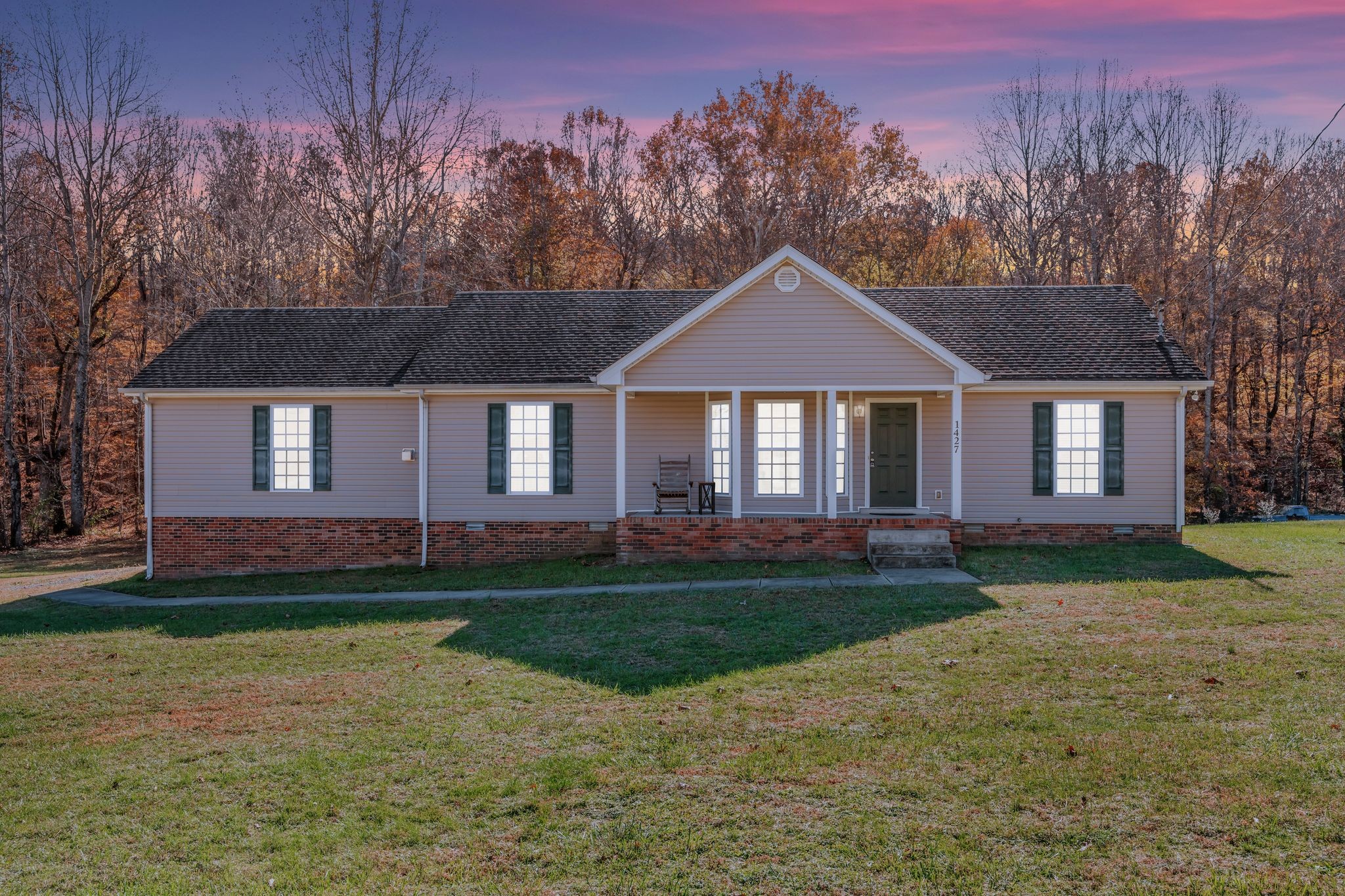 1427 St Paul Road Charlotte, TN 37036 - Photo 1 of 38 a front view of a house with a garden and trees