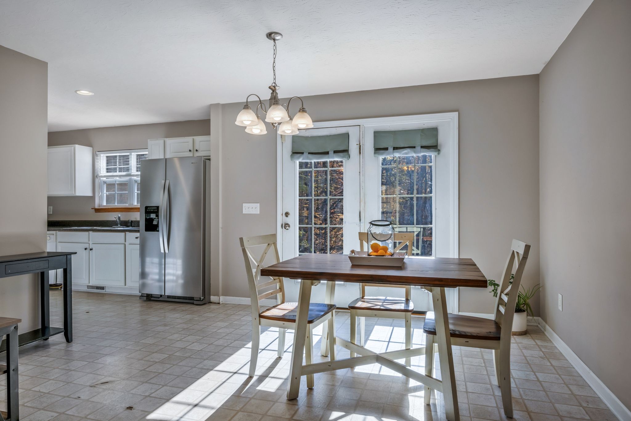 1427 St Paul Road Charlotte, TN 37036 - Photo 12 of 38 a dining room with furniture a chandelier and wooden floor