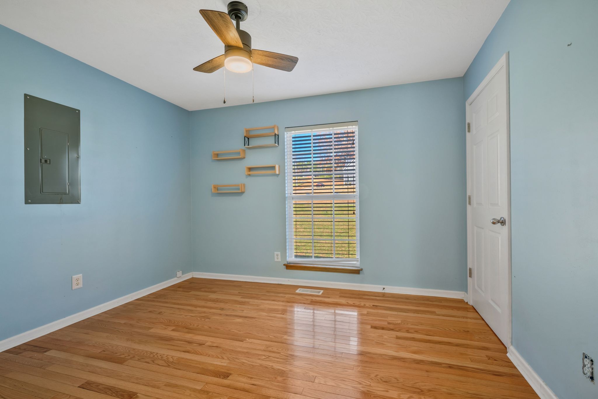 1427 St Paul Road Charlotte, TN 37036 - Photo 19 of 38 a view of empty room with wooden floor and fan