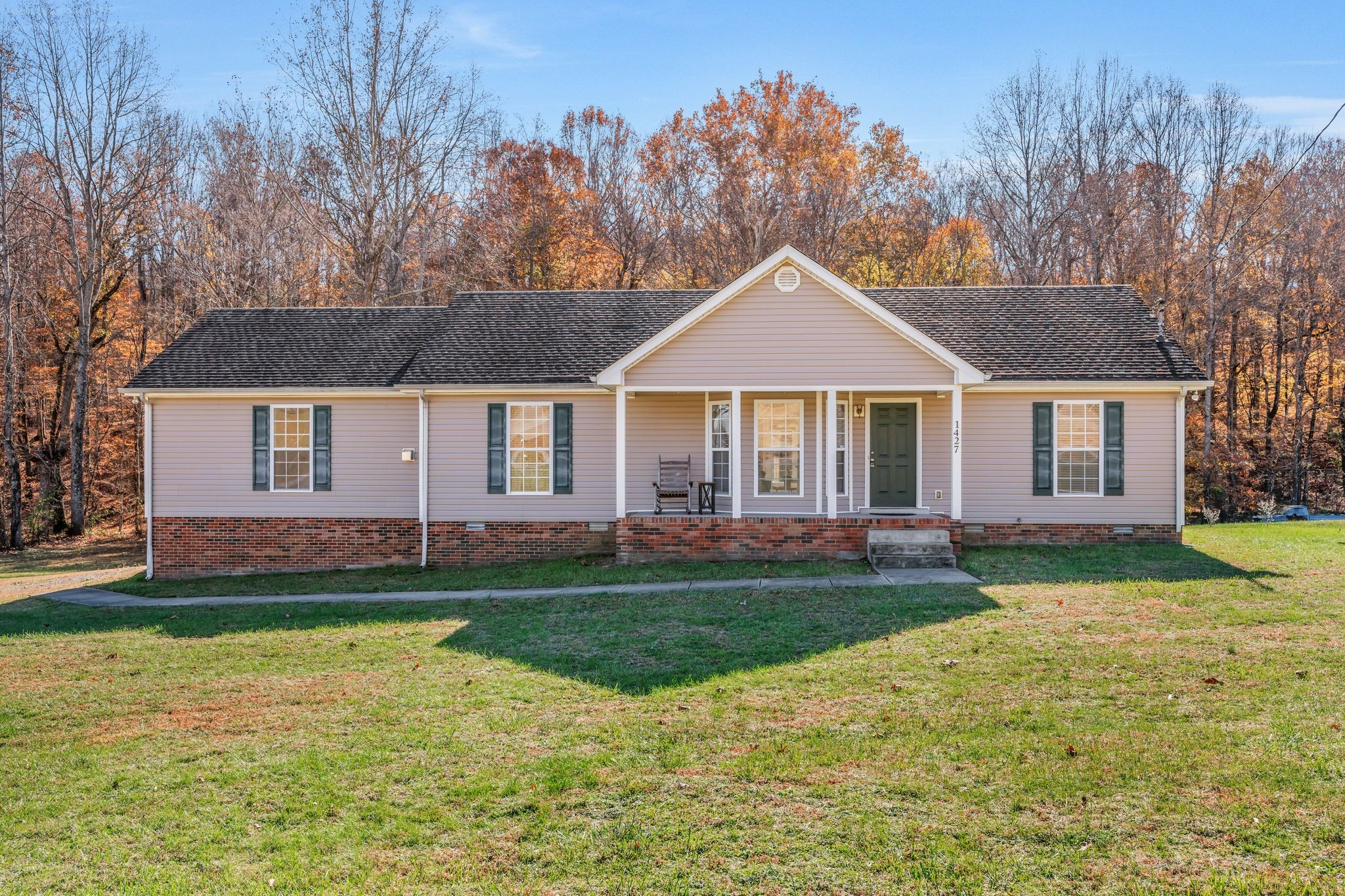 1427 St Paul Road Charlotte, TN 37036 - Photo 36 of 38 a front view of a house with a garden and trees