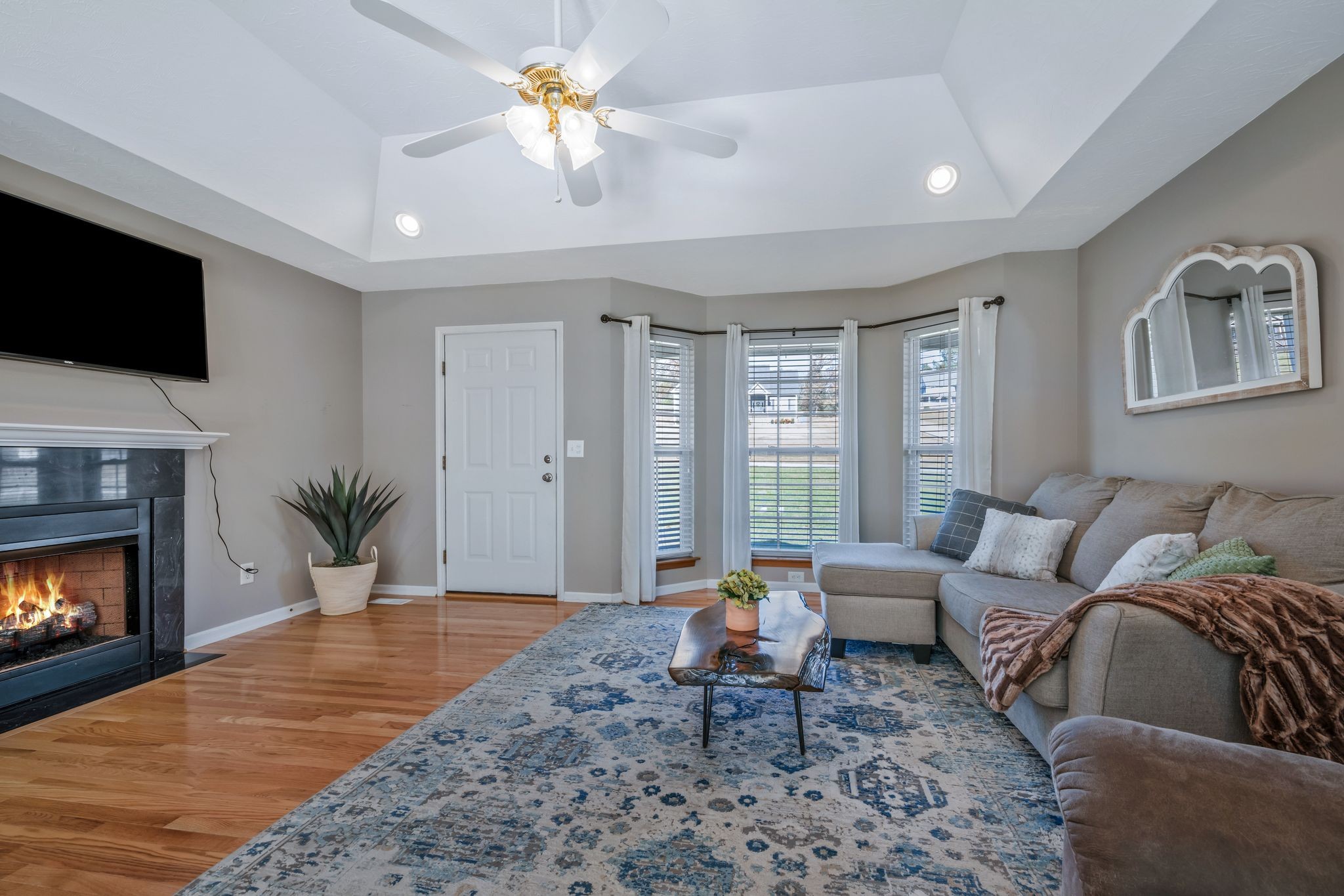 1427 St Paul Road Charlotte, TN 37036 - Photo 5 of 38 a living room with furniture a fireplace and a flat screen tv