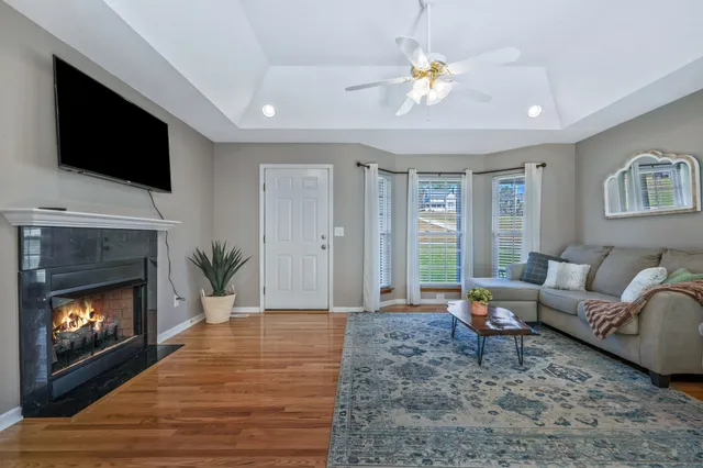 a view of a livingroom with furniture wooden floor and a fireplace